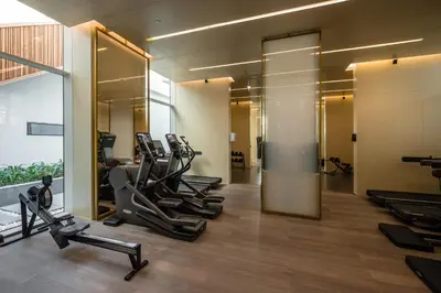 a gym with treadmills and ellipticals in a building at Maison Privee - Glamourous Apt with Sea Views at FIVE Palm in Dubai
