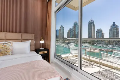 a bedroom with a bed and a large window at Vacay Lettings- Stylish waterfront getaway home in Dubai