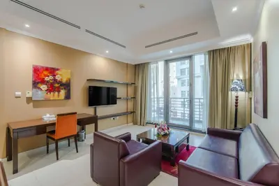 a living room with a couch and a desk in a room at Icon Delux Hotel Apartments Al Barsha - Formerly Abidos in Dubai