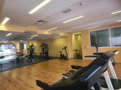 a gym with treadmills and exercise bikes in a room at 1bd apt plus study I Close to mall I Fast wi-fi in Dubai