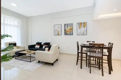 a living room with a table and a couch at 1bd apt plus study I Close to mall I Fast wi-fi in Dubai