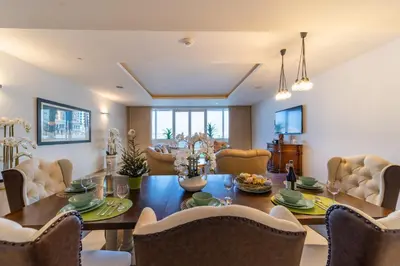 a dining room with a table and chairs at 2 Bedroom App with private beach and infinity pool in Dubai