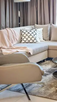 a living room with a couch and a chair at Luxury apartment Paramount Hotel A21 in Dubai