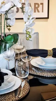 a table with plates and wine glasses on it at Luxury apartment Paramount Hotel A21 in Dubai