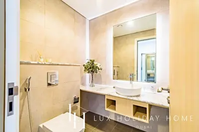 a bathroom with a sink and a mirror at LUX Paramount Burj View Business Bay in Dubai