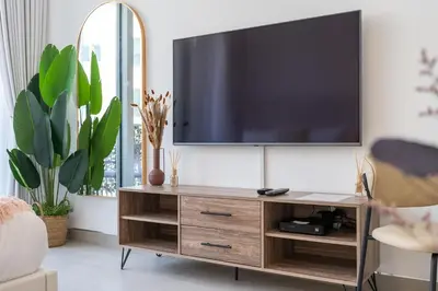 a living room with a flat screen tv on a wall at Work & Relax & Chill in JVC in Dubai