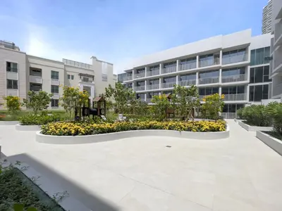 an empty courtyard in front of a building at Brand New & Modern Studio in JVC in Dubai