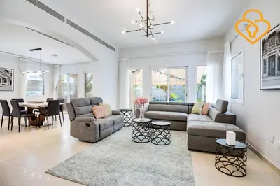 a living room with a couch and a dining room at Keysplease Amazing 2 B/R Villa With private Pool, JVT in Dubai