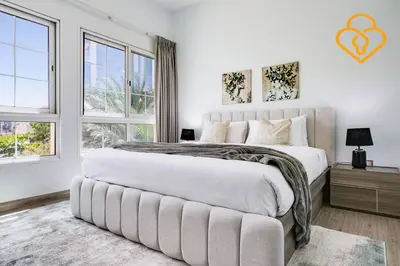 a white bedroom with a large bed and windows at Keysplease Amazing 2 B/R Villa With private Pool, JVT in Dubai