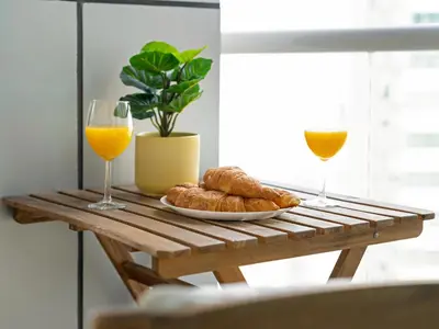 a table with two glasses of orange juice and croissants at Relax & Unwind in This Cozy 2BR Apartment in Dubai