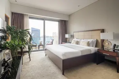a bedroom with a large bed and a large window at Frank Porter - Emaar Residences Dubai Marina in Dubai