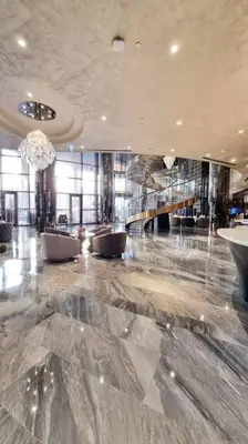 a lobby with a large marble floor and a chandelier at Amazing Paramount Hotel apartment D48 in Dubai