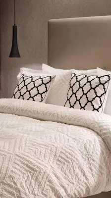 a white bed with pillows and a laptop on it at Amazing Paramount Hotel apartment D48 in Dubai