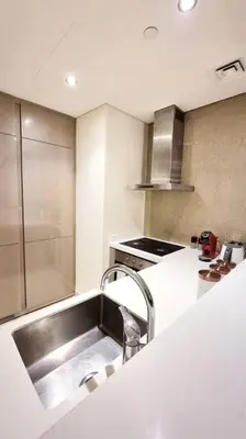 a kitchen with a sink and a stove at Amazing Paramount Hotel apartment D48 in Dubai