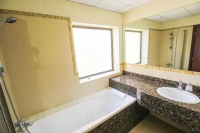 a bathroom with a bath tub and a sink at 2BR Jumeirah Beach front Residence in Dubai