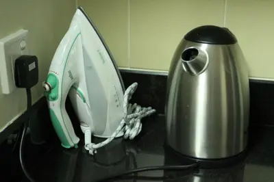 a white and green appliance sitting on a counter next to a coffee pot at 2BR Jumeirah Beach front Residence in Dubai