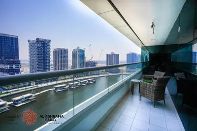 a balcony with a view of a river and buildings at Alashrafia Saray - Superb 1 BR in Canal Views in Dubai