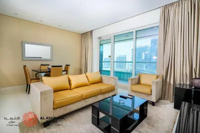 a living room with a couch and a table at Alashrafia Saray - Superb 1 BR in Canal Views in Dubai