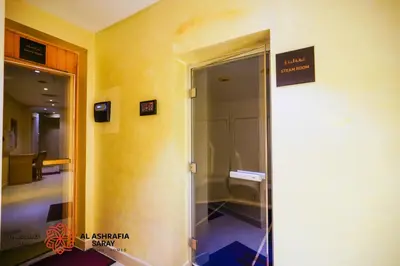 an elevator in a building with a sign on the wall at Alashrafia Saray - Fabulous 1BR in Canal Views in Dubai