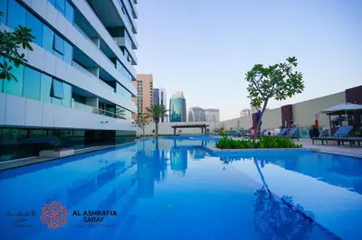 a swimming pool in front of a building at Alashrafia Saray - Fabulous 1BR in Canal Views in Dubai