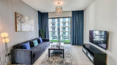 a living room with a couch and a tv at STAY BY LATINEM Luxury 1BR Holiday Home G61024 near Burj Khalifa in Dubai