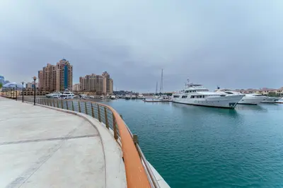a marina with boats in the water and buildings at Maison Privee - Splendid Apt on The Palm with Stunning Sea Views in Dubai