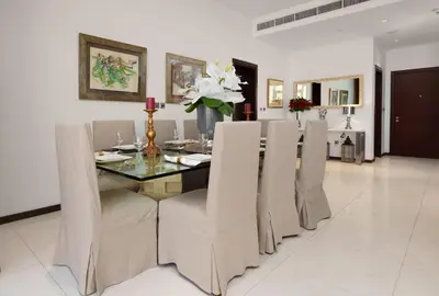 a dining room with a glass table and chairs at Maison Privee - Splendid Apt on The Palm with Stunning Sea Views in Dubai