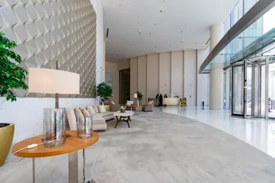 a lobby with a couch and a table at Prestige Living 1BR with Full Burj Khalifa View by Auberge in Dubai