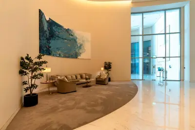 a living room with a couch and a painting on the wall at Prestige Living 1BR with Full Burj Khalifa View by Auberge in Dubai