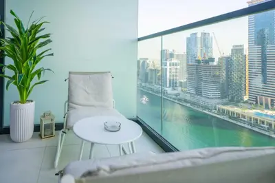 a room with a couch and a table and a window at EasyGo - Affordable 1br Close to Public Transit - Zad-13 in Dubai