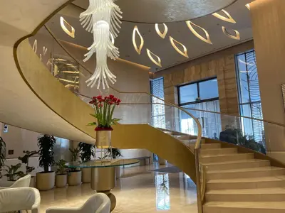 a lobby with a spiral staircase and a stair case at LHG PALM JUMEIRAH Tallest RoofTop Pool in Dubai