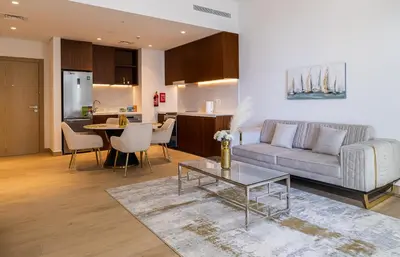 a living room with a couch and a table at Apartment with Partial Sea View in La Mer in Dubai