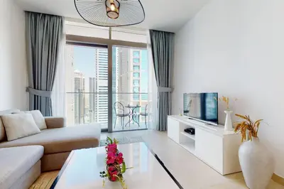 a living room with a couch and a tv at Marina Gate 1, Dubai Marina - Chic One Bedroom in Dubai