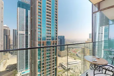 a balcony with a view of a city with tall buildings at Marina Gate 1, Dubai Marina - Chic One Bedroom in Dubai