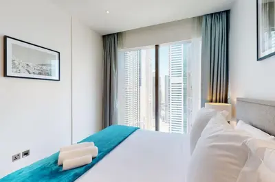 a bedroom with a large bed and a large window at Marina Gate 1, Dubai Marina - Chic One Bedroom in Dubai