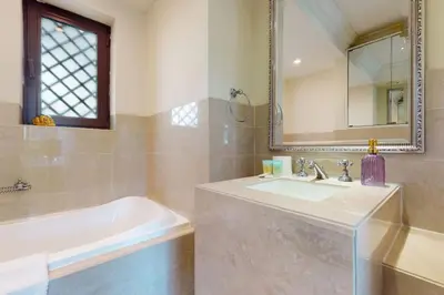 a bathroom with a sink and a tub and a mirror at Al Tajer, Core C, Souk Al Bahar - Charming Two Bedroom in Dubai