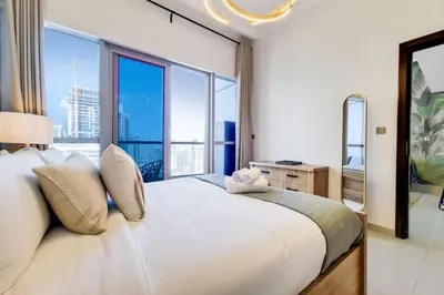 a bedroom with a large white bed with a large window at Bay Central, Dubai Marina - Exquisite One Bed with Marina View in Dubai