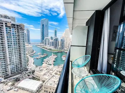 a balcony with chairs and a view of a harbor at Charming 1BR Apart With Stunning Sea&Marina Views in Dubai