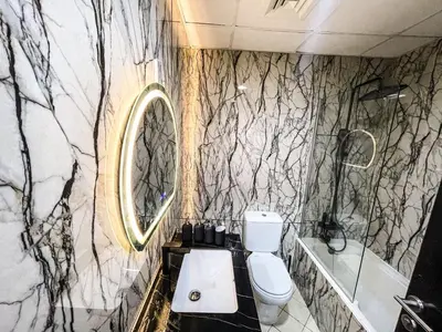 a bathroom with a toilet and a sink and a mirror at Charming 1BR Apart With Stunning Sea&Marina Views in Dubai