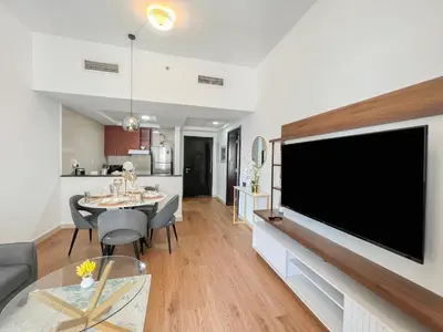 a living room with a large flat screen tv on a wall at Charming 1BR Apart With Stunning Sea&Marina Views in Dubai