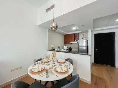 a kitchen with a table and chairs in a room at Charming 1BR Apart With Stunning Sea&Marina Views in Dubai
