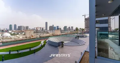 a view of a city skyline from a building at Stylish Studio - Panoramic Pool View - JVC in Dubai