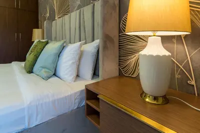 a bedroom with a bed and a lamp on a table at Amazing BeachFront Apartments near Atlantis Waterpark by Simply Comfort Sarai Palm Jumeirah in Dubai
