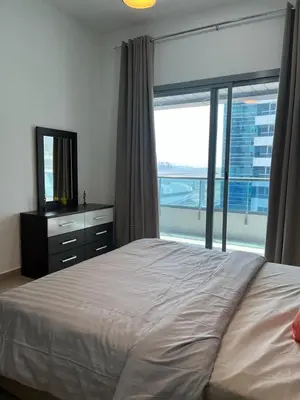 a bedroom with a large bed and a large window at Elegant stay at marina Dubai in Dubai