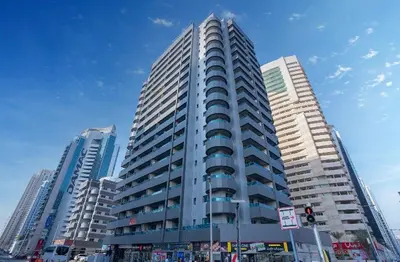 a tall building in a city with two tall buildings at Elegant stay at marina Dubai in Dubai