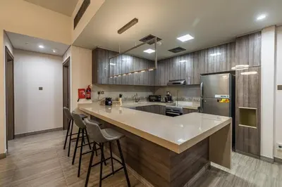 a kitchen with a large island with bar stools at MBL I Modern 2 Bedroom Apartment in JLT in Dubai