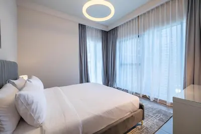 a bedroom with a bed and a large window at MBL I Modern 2 Bedroom Apartment in JLT in Dubai