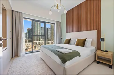 a bedroom with a large bed and a large window at Silkhaus Burj Royale 1BDR with balcony in Downtown in Dubai