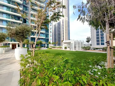 a park in the middle of a city with tall buildings at Seaside Serenity: 1-BR Apartment with Beach Access in Dubai