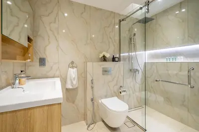 a bathroom with a shower and a toilet and a sink at GuestReady - Lux interiors in Dubai Marina in Dubai